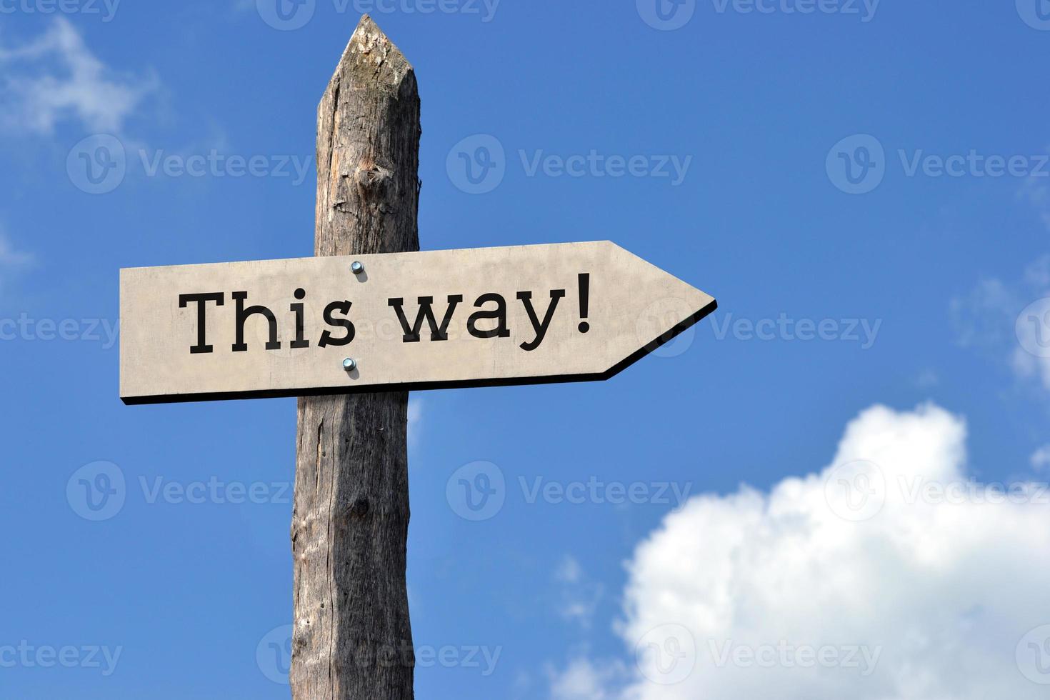 This Way - Wooden Signpost with one Arrow, Sky with Clouds photo