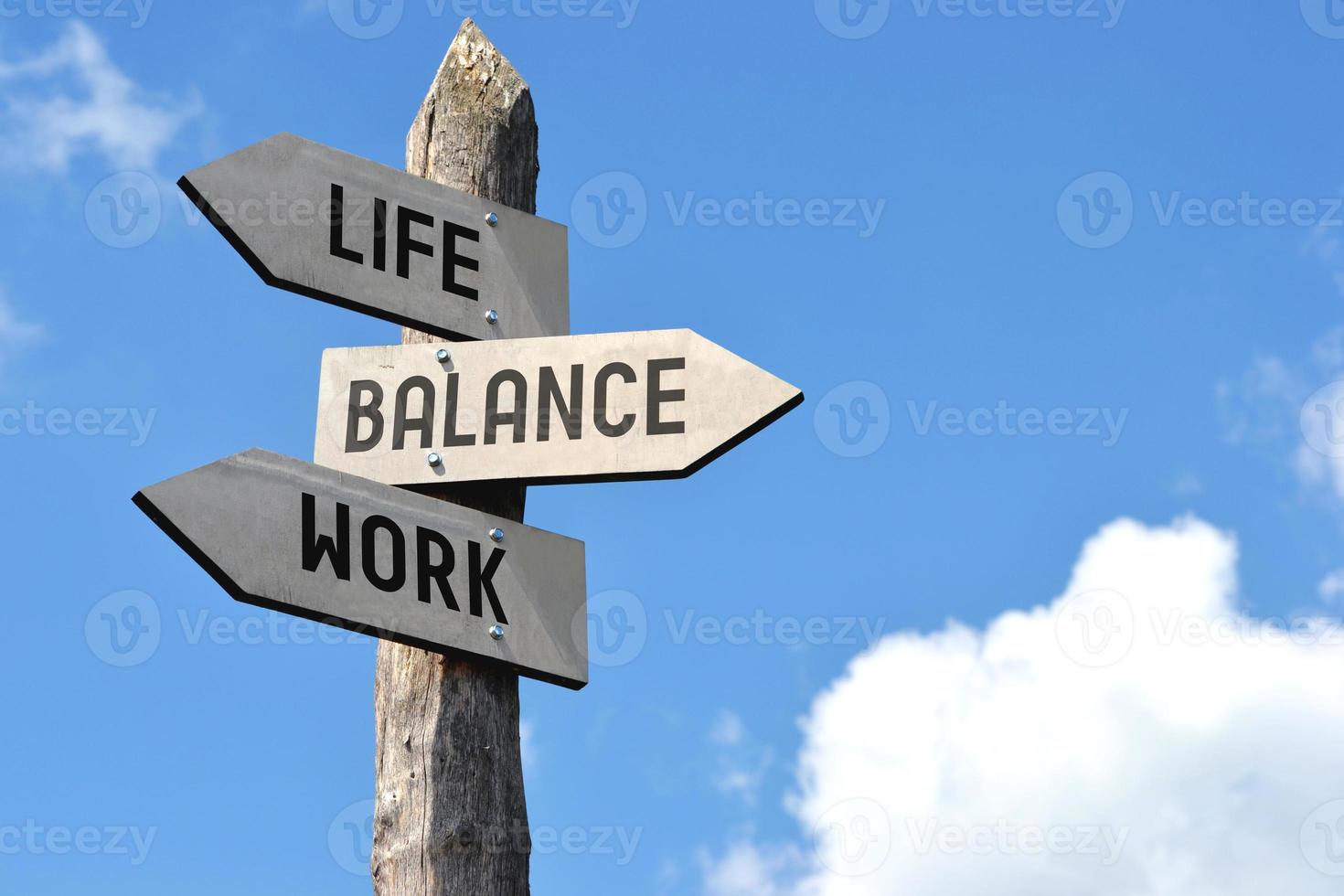 Life, Balance, Work - Wooden Signpost with Three Arrows photo