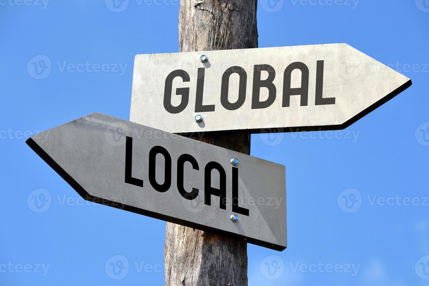 Global and Local - Wooden Signpost with Two Arrows photo