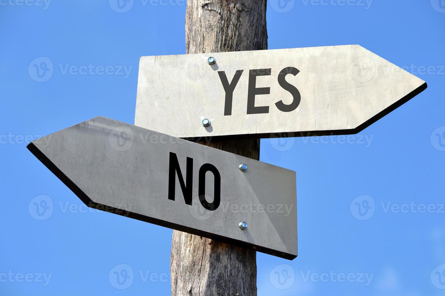 Yes and No - Wooden Signpost with Two Arrows photo