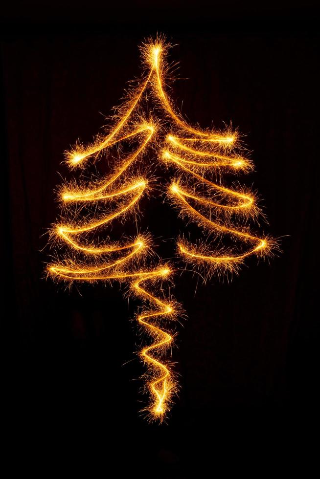 Tree made with sparklers ready for your inscriptions on black background photo