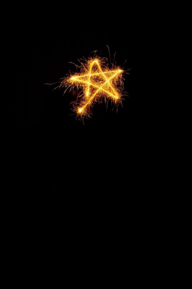 Star made with sparklers ready for your inscriptions on black background photo
