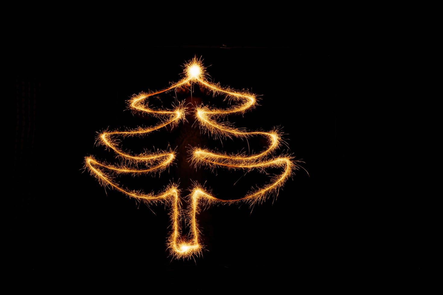 Tree made with sparklers ready for your inscriptions on black background photo