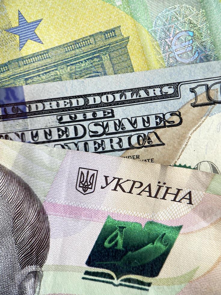 close up of Ukrainian hryvnia, euro and USD banknotes photo