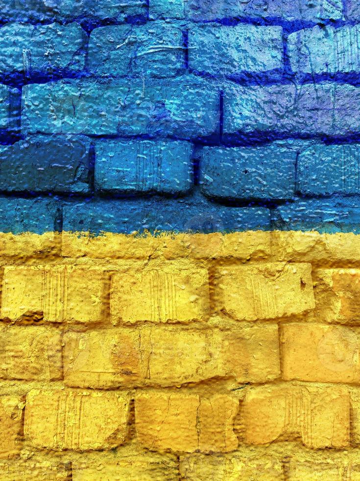 Ukrainian flag painted on brick wall photo