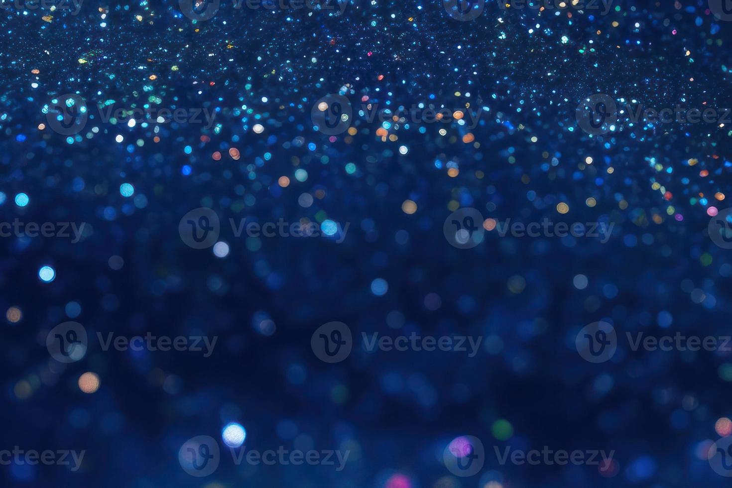 glitter particles on blue dark background, bokeh and sparkles backdrop photo