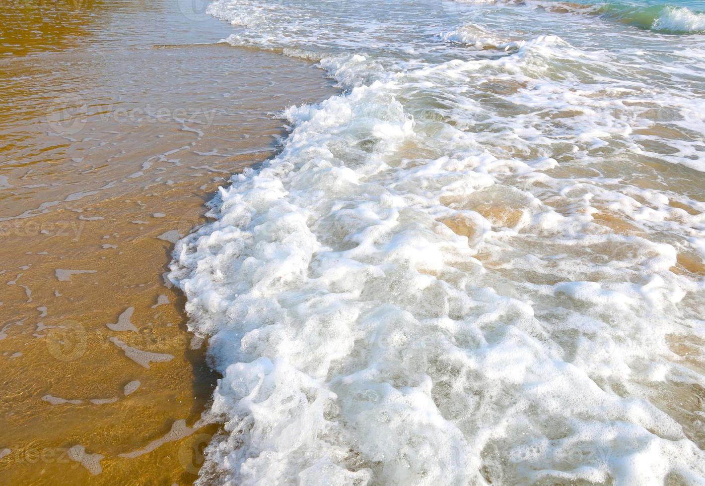 Beach with wave and blue sea water background photo