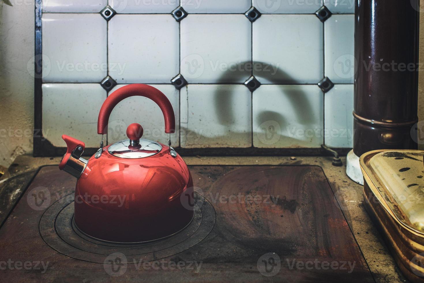 Modern teapot on top of antique cheap stove top photo