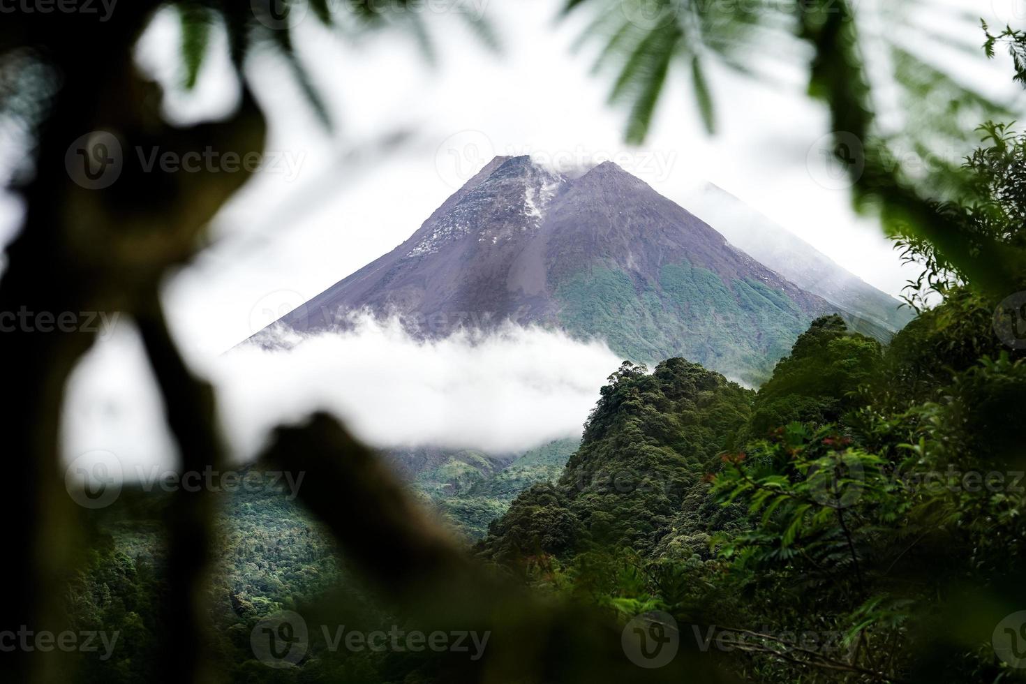 View of Mount Merapi in the morning, and slightly covered by clouds. Potentially eruptive volcano. photo