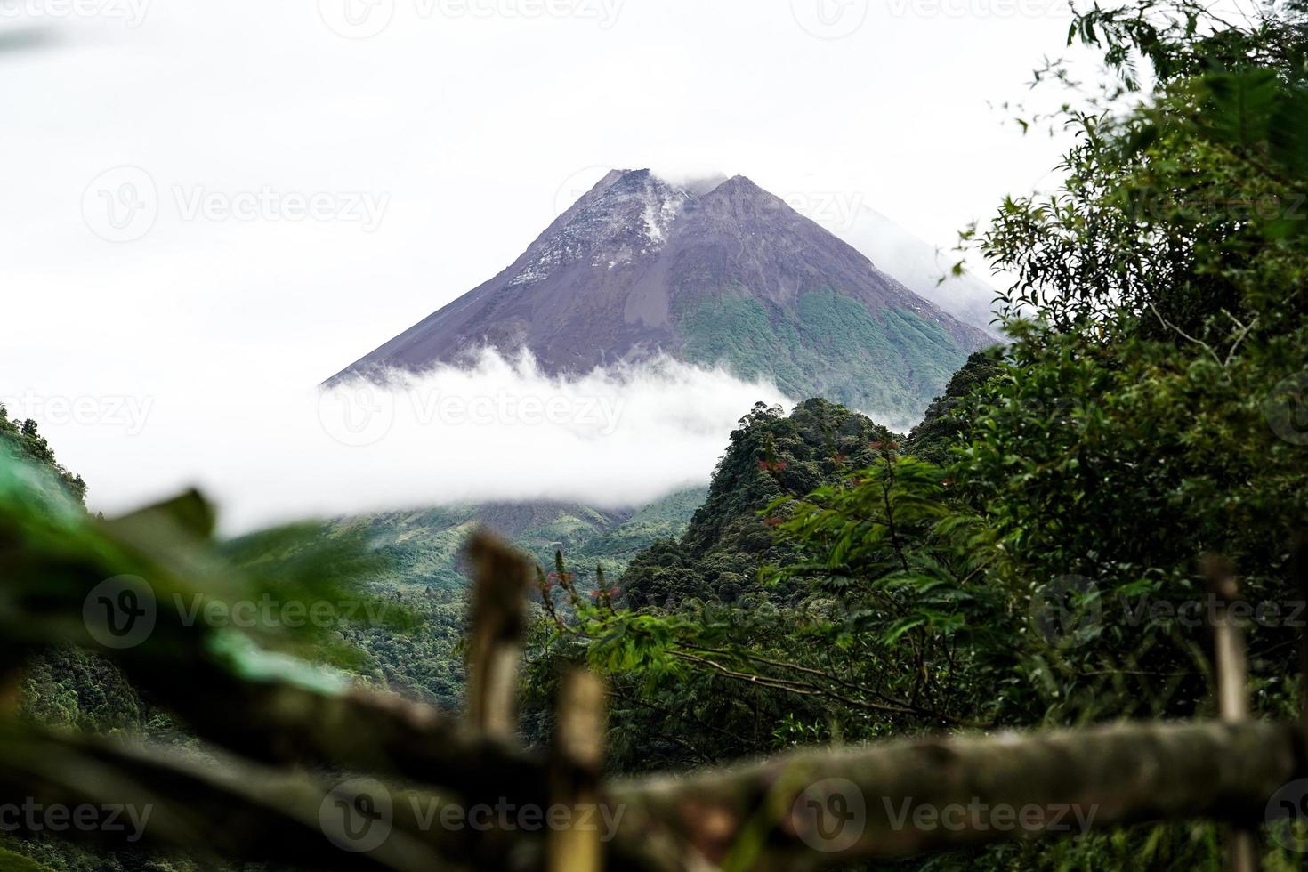 View of Mount Merapi in the morning, and slightly covered by clouds. Potentially eruptive volcano. photo