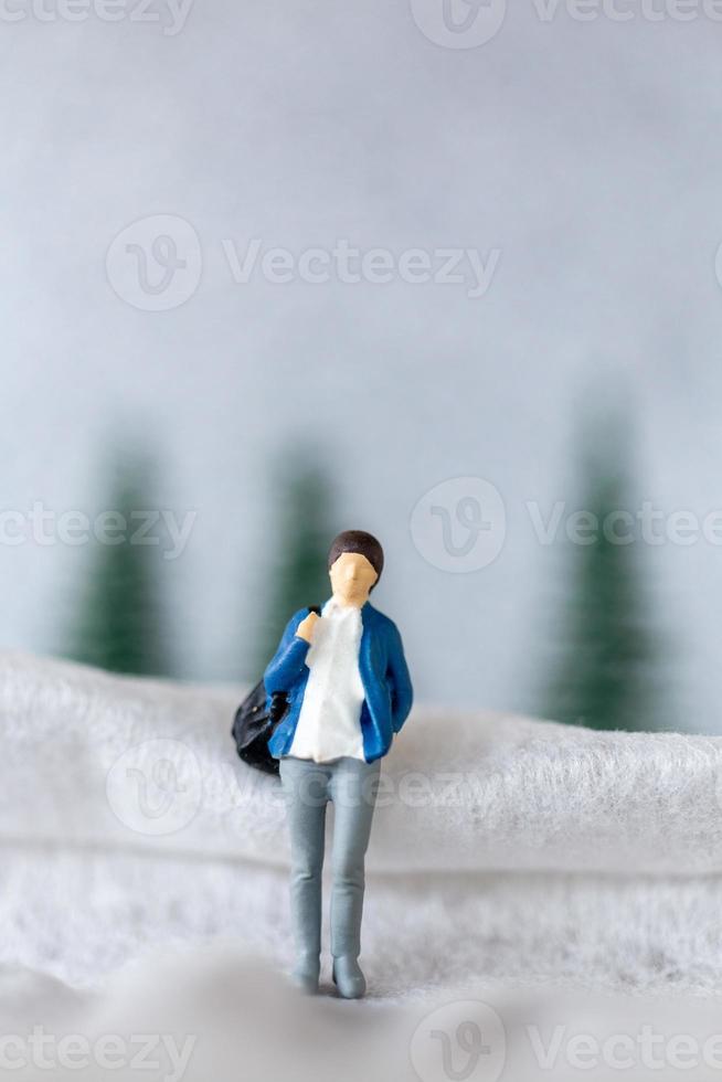 Miniature people woman Travel in winter time photo