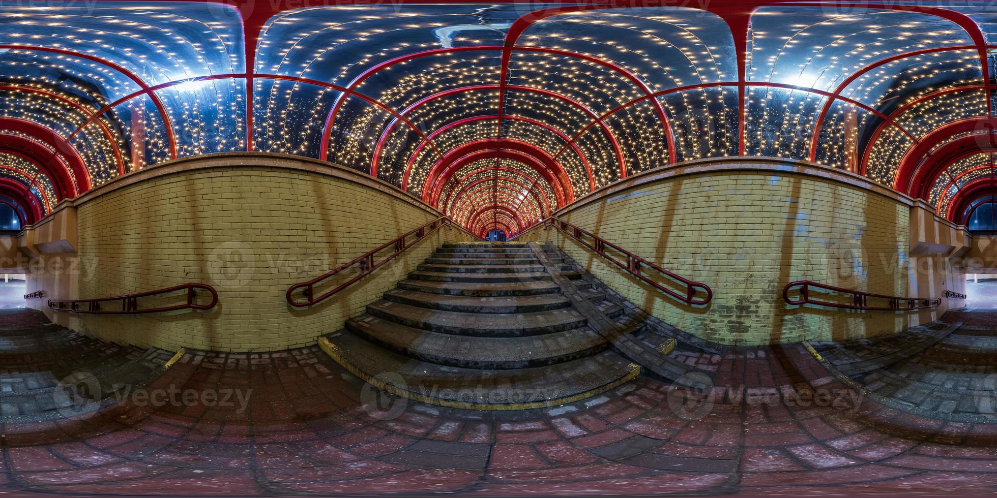 spherical night 360 panorama in festively lit underground passage tunnel with red frame arch and transparent dome and concrete staircase in equirectangular seamless projection, for VR AR content photo