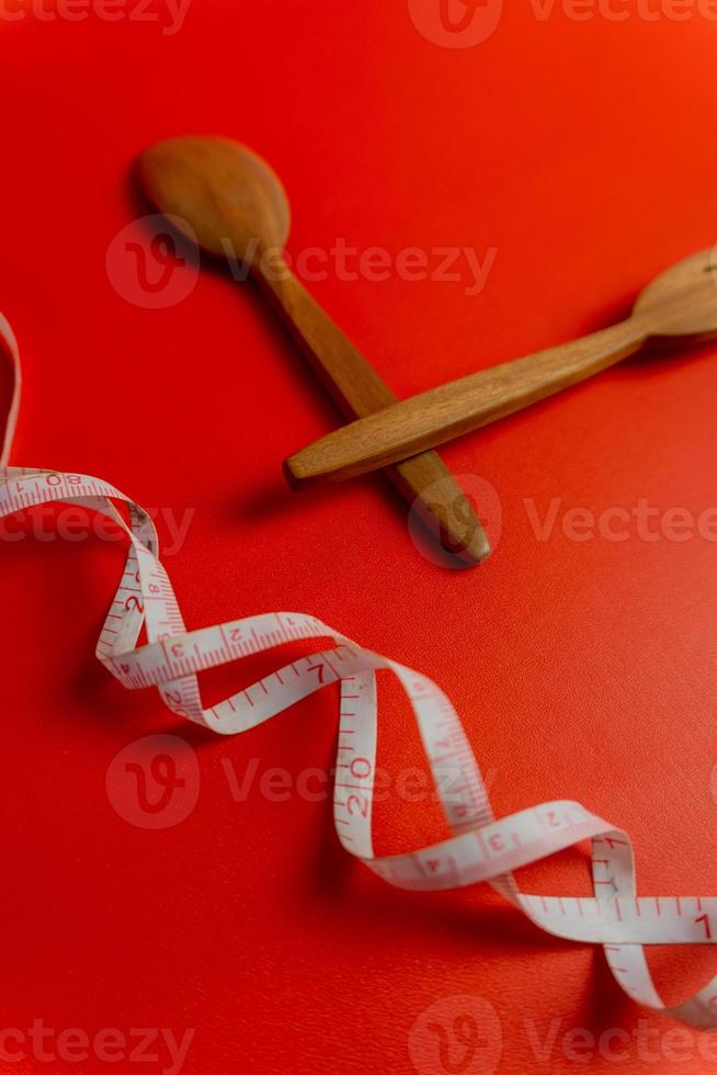 Diet food concept and fat loss. wooden fork and spoon. concept of intermitten fasting. photo