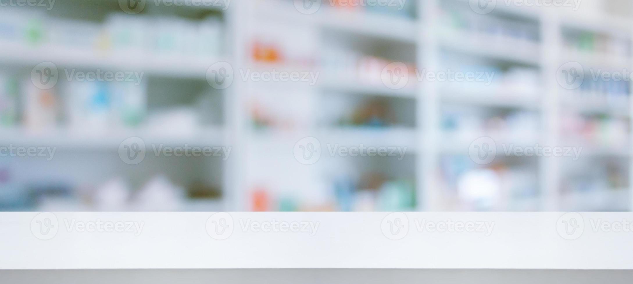 Empty white counter with pharmacy drugstore shelves blurred background photo