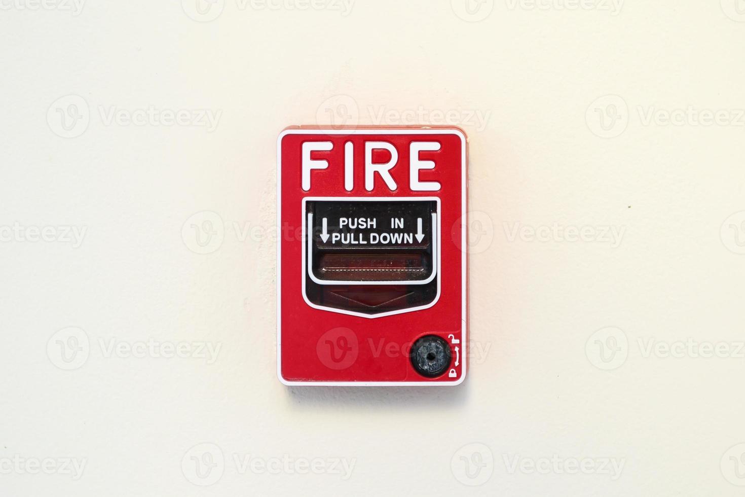 Fire alarm switch on white wall background photo