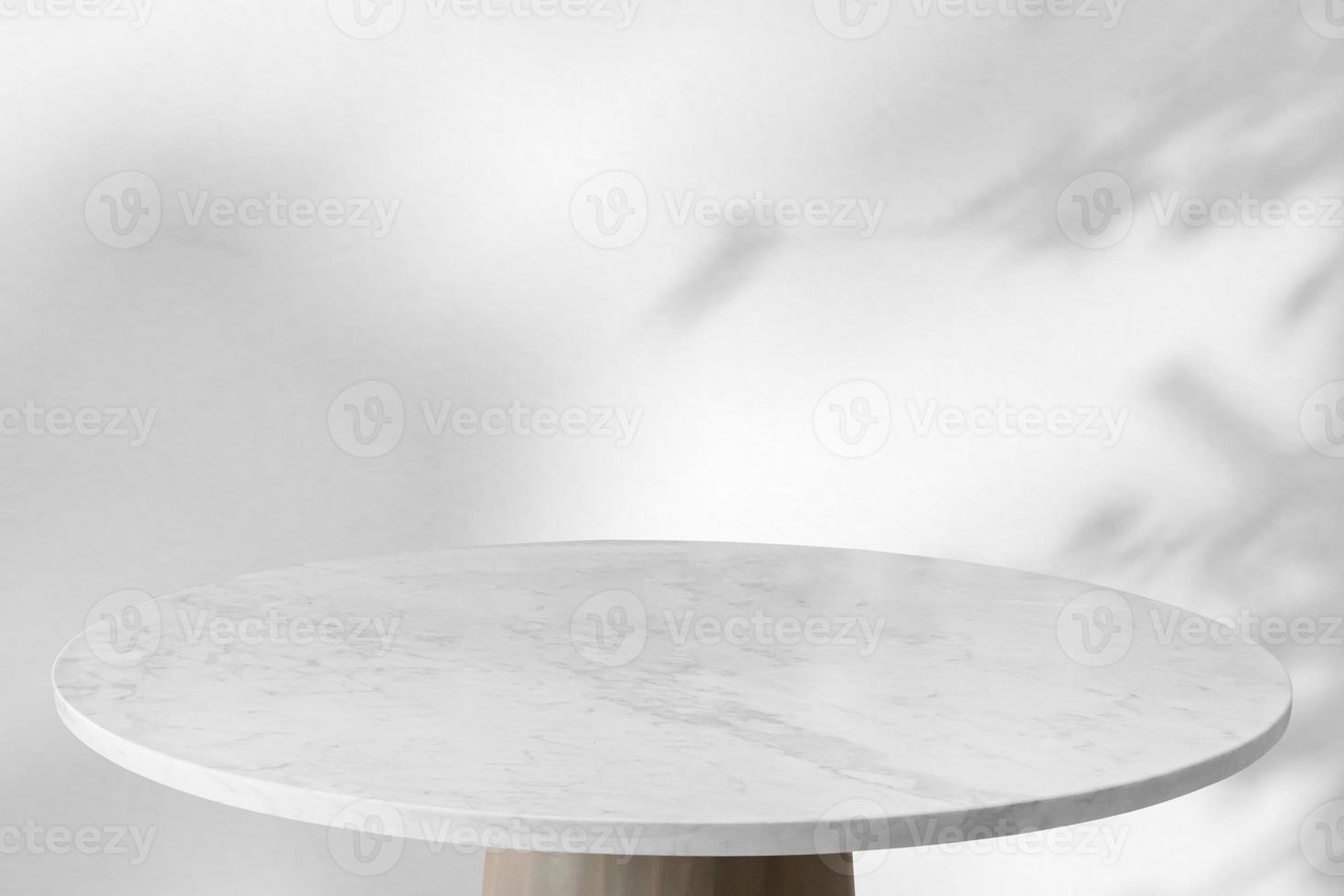 Marble table with tree shadow drop on white wall background for mockup product display photo