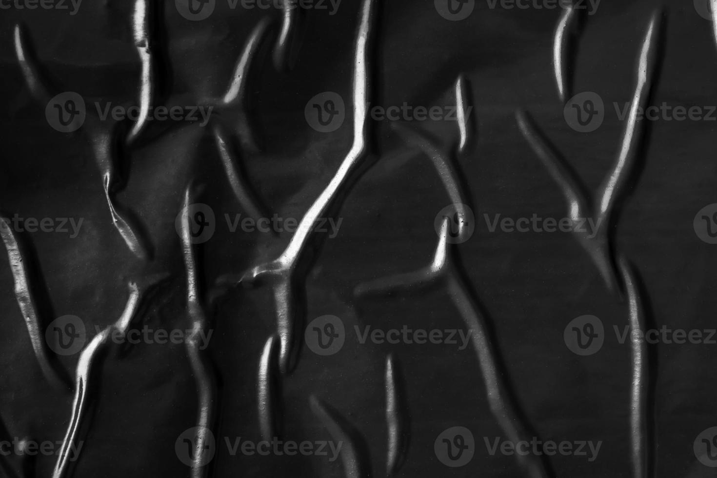 black crumpled and creased plastic poster texture background photo