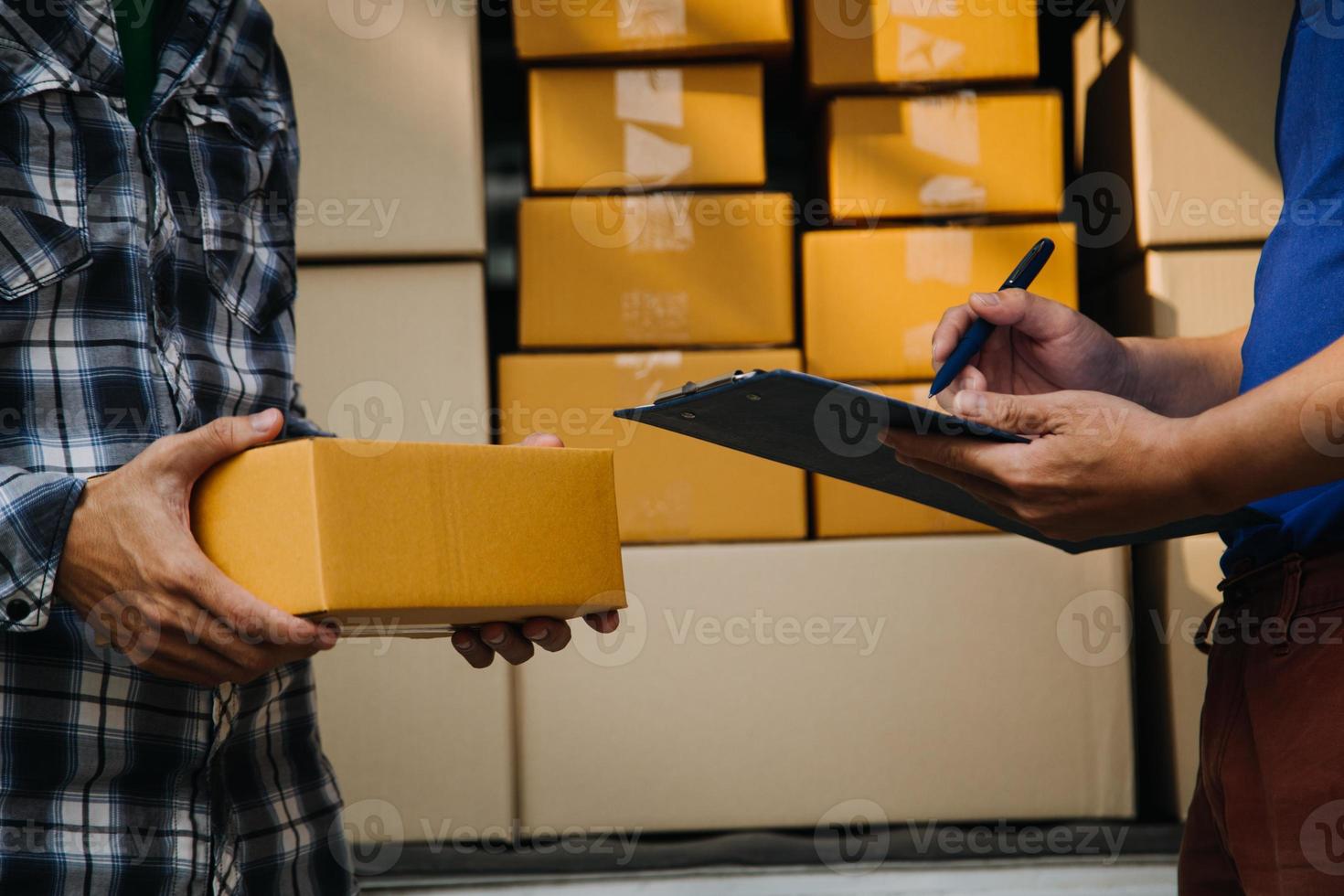 Delivery man with protective mask and gloves delivering parcels during lockdown and pandemic and holding mobile contactless payment machine photo