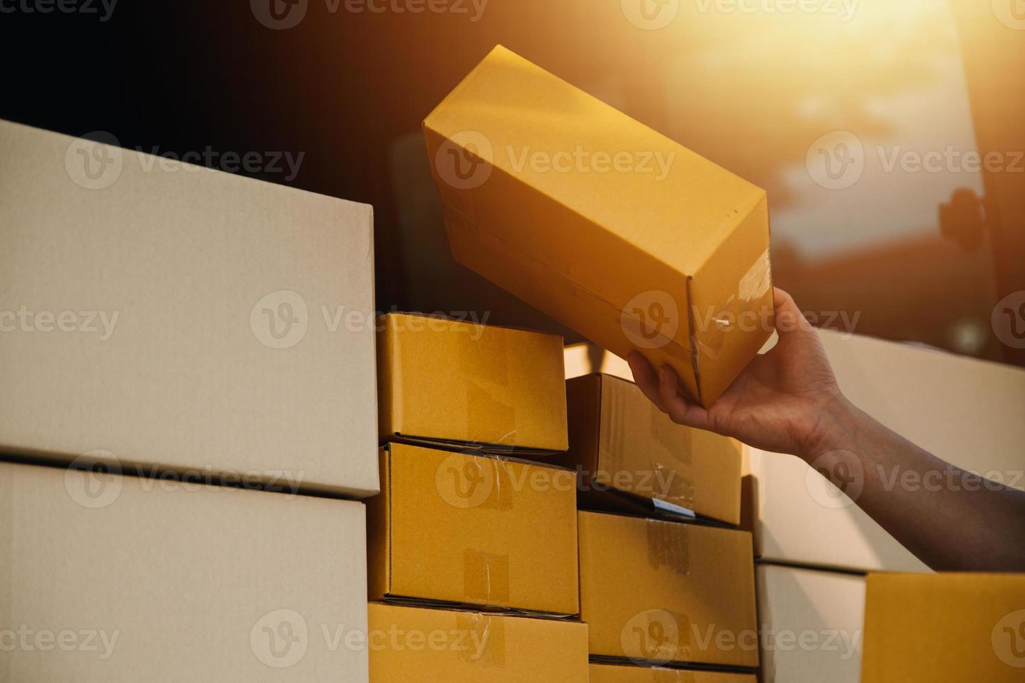 Delivery man with protective mask and gloves delivering parcels during lockdown and pandemic and holding mobile contactless payment machine photo