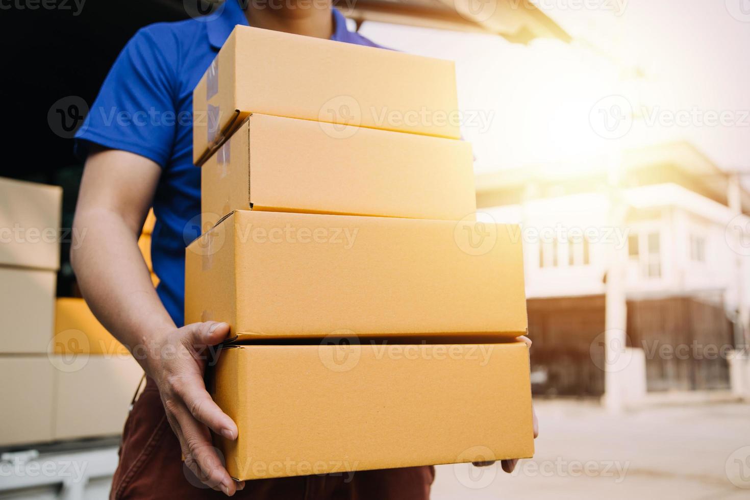 Delivery man with protective mask and gloves delivering parcels during lockdown and pandemic and holding mobile contactless payment machine photo