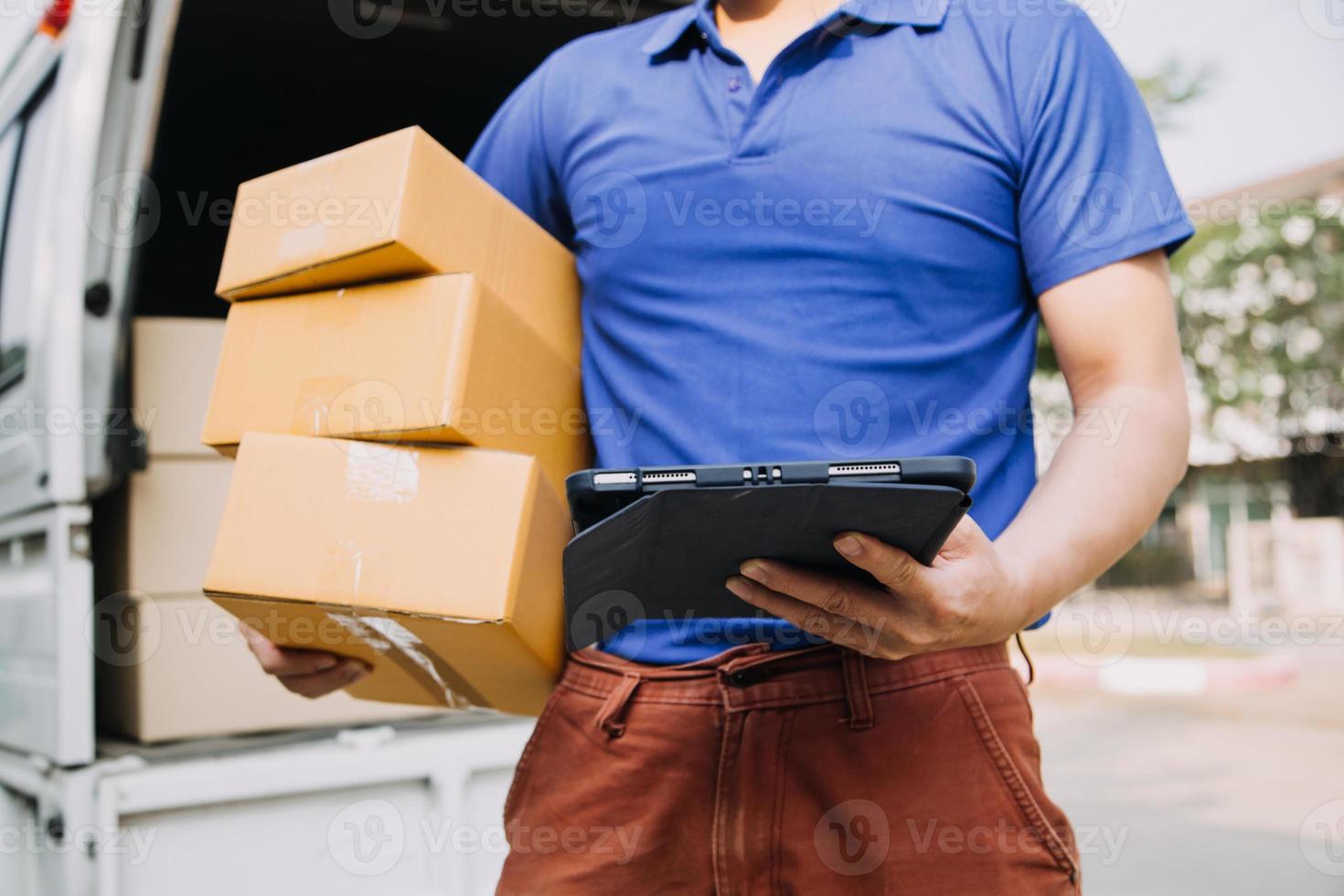 Delivery man with protective mask and gloves delivering parcels during lockdown and pandemic and holding mobile contactless payment machine photo