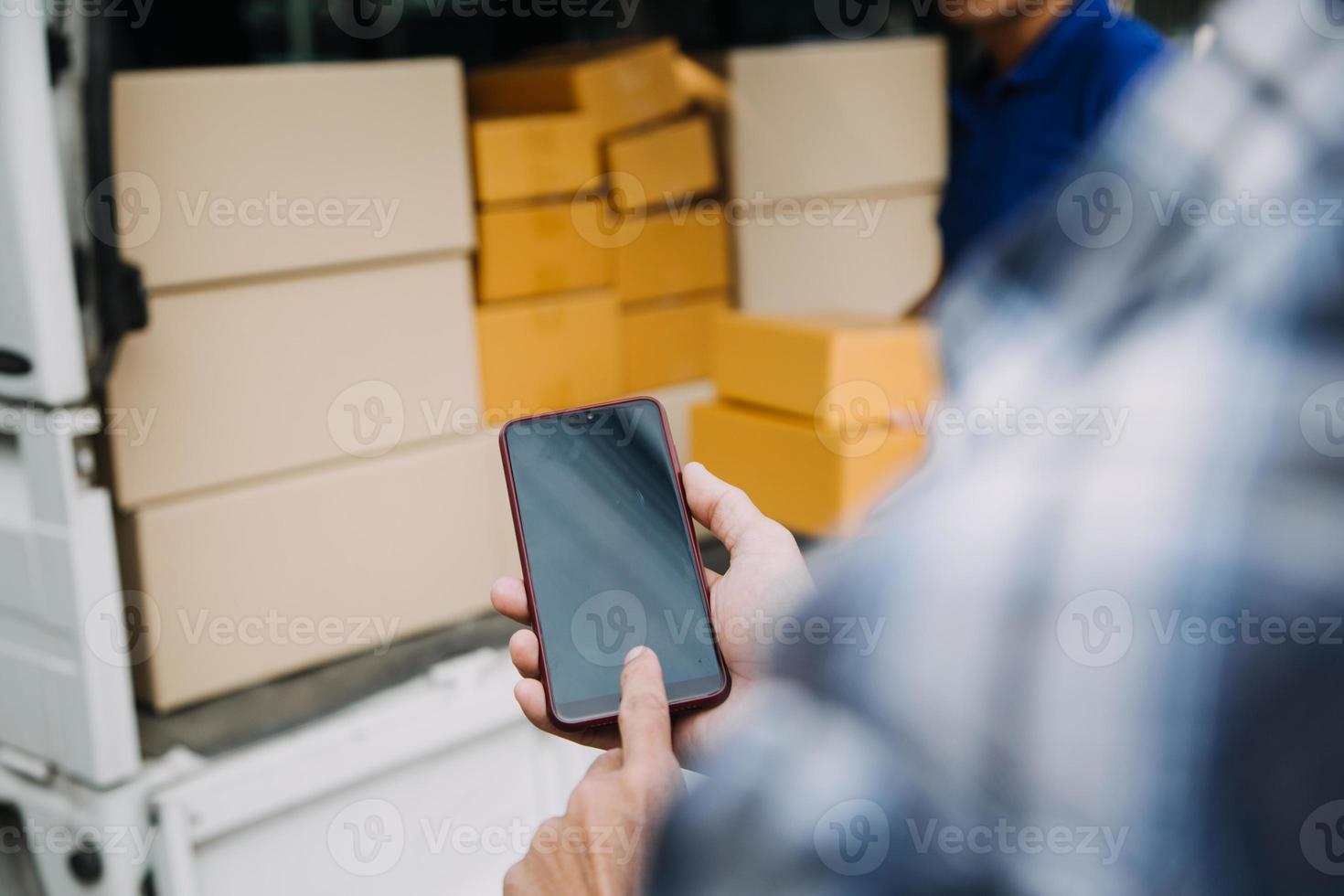 Delivery man with protective mask and gloves delivering parcels during lockdown and pandemic and holding mobile contactless payment machine photo