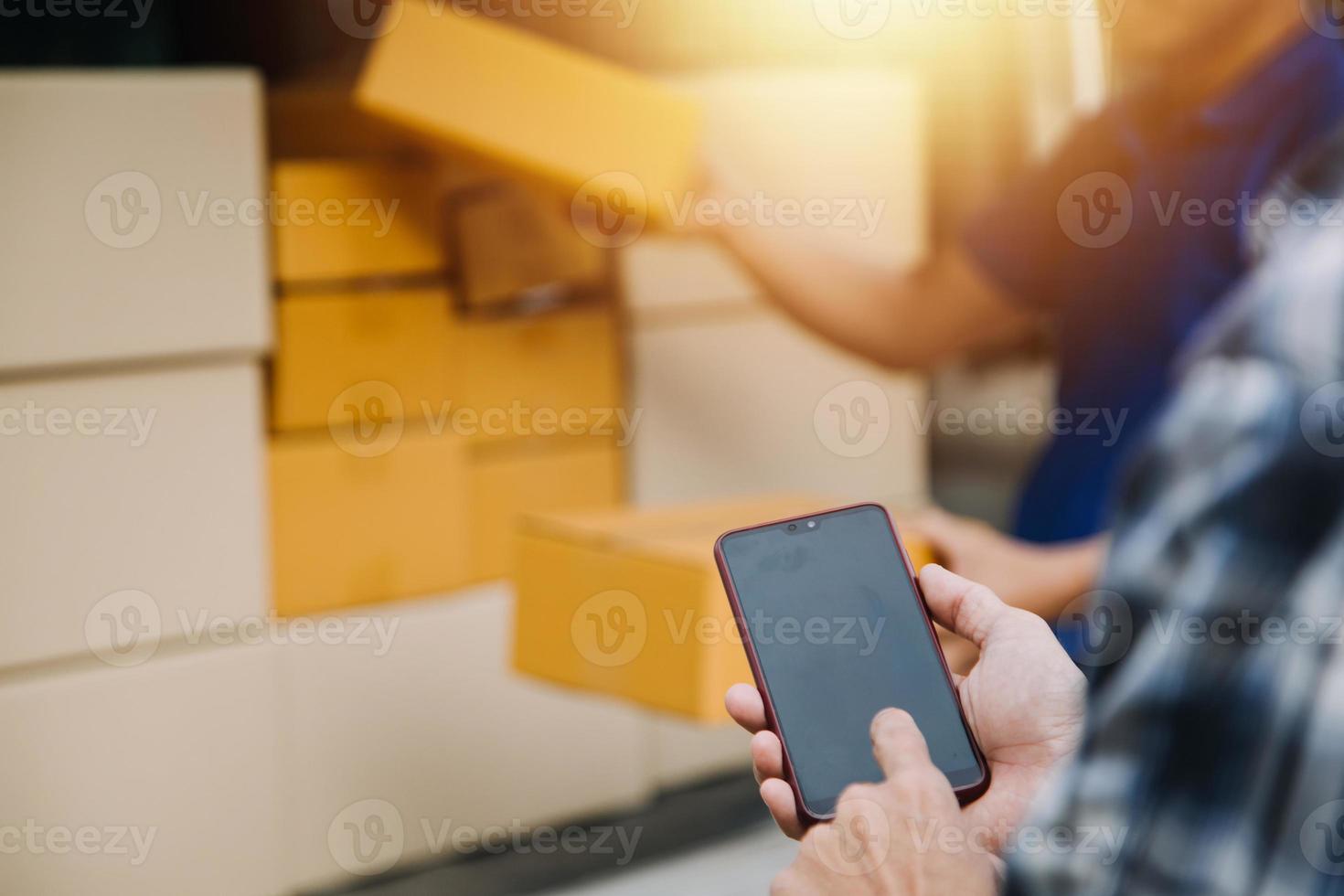 Delivery man with protective mask and gloves delivering parcels during lockdown and pandemic and holding mobile contactless payment machine photo