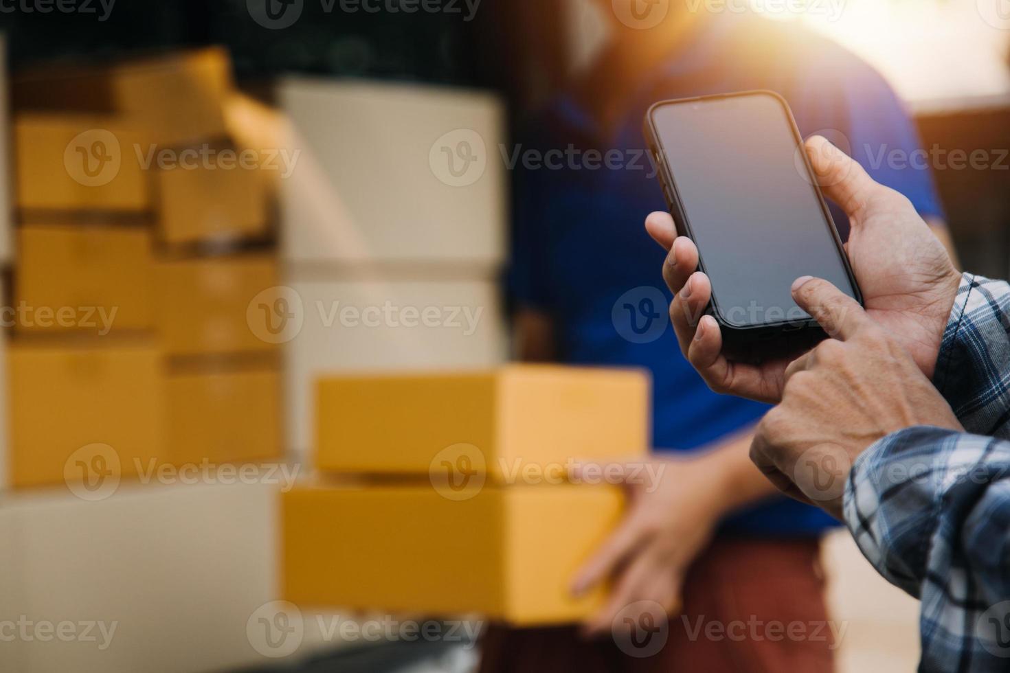 Delivery man with protective mask and gloves delivering parcels during lockdown and pandemic and holding mobile contactless payment machine photo