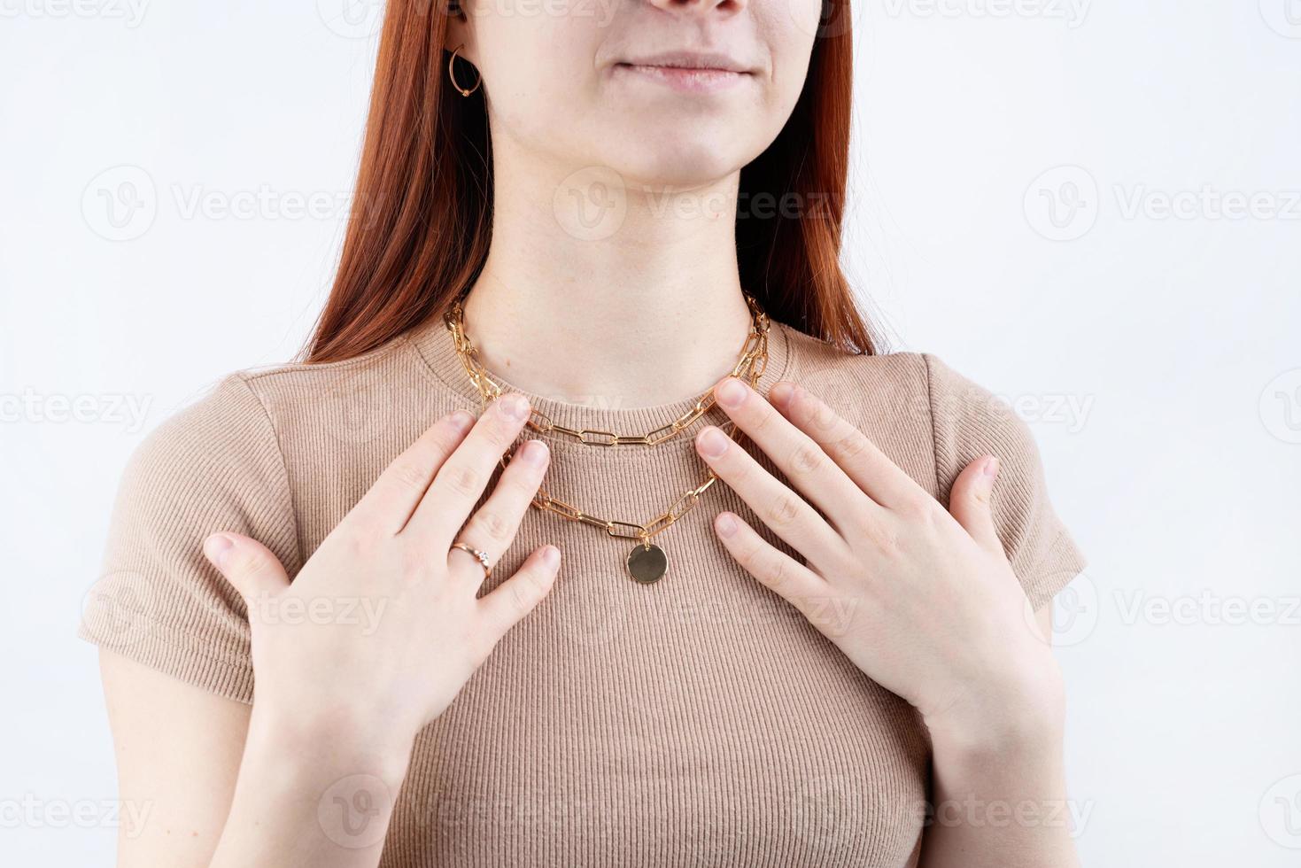 Women wearing jewelry pendant necklace with on close-up photo