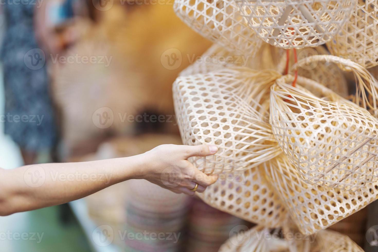 Tourist hand holding Craft bamboo basket in Chatuchak Weekend Market, landmark and popular attractions in Bangkok, Thailand. Travel in Southeast Asia concept photo