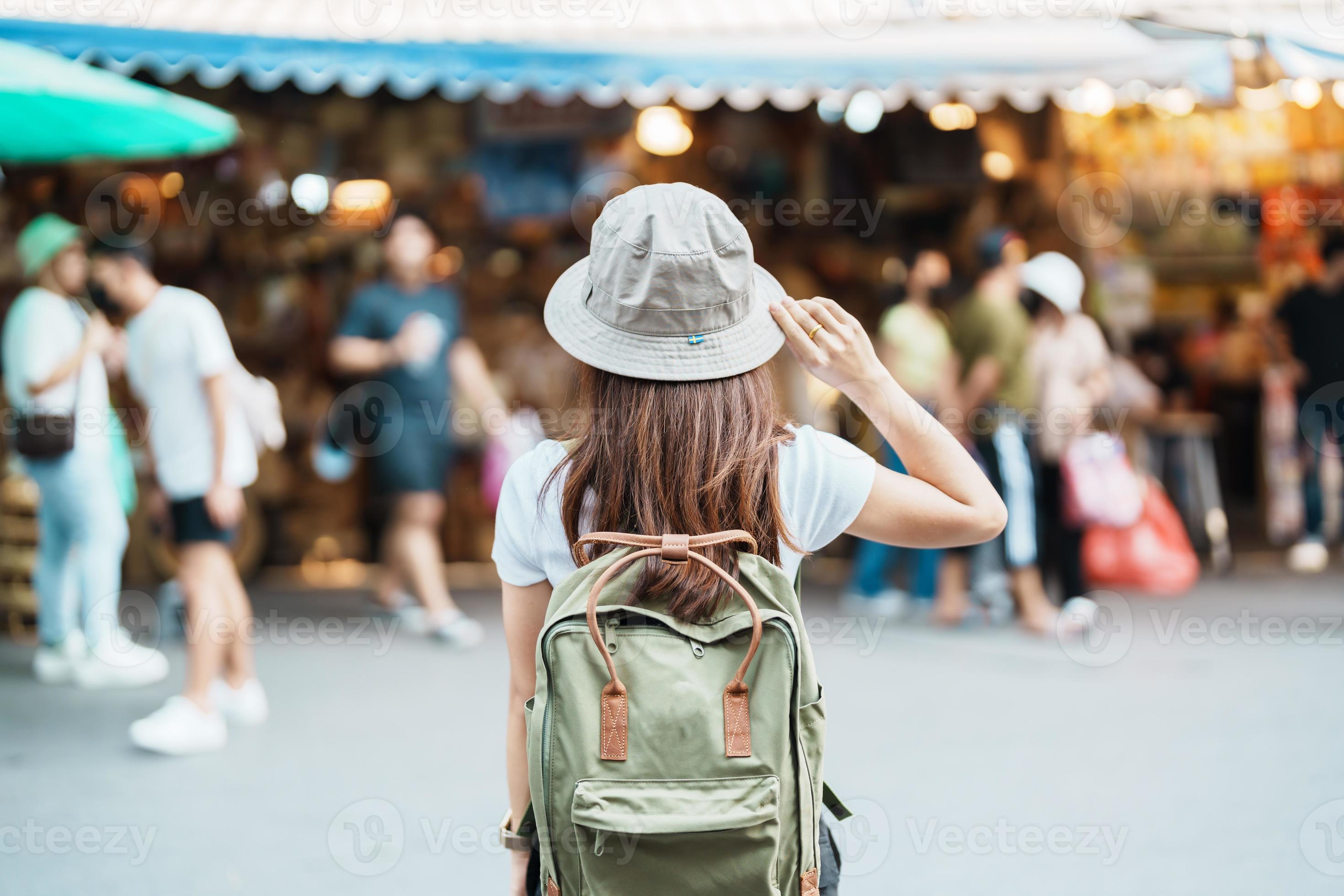 woman traveler visiting in Bangkok, Tourist with backpack and hat  sightseeing in Chatuchak Weekend Market, landmark and popular attractions  in Bangkok, Thailand. Travel in Southeast Asia concept 21601287 Stock Photo  at Vecteezy