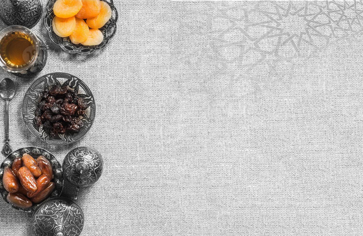 A black bowl of dried fruit on a gray background . .a background for Ramadan. Social media posts .Muslim Holy Month Ramadan Kareem .Ramadan Mubarak beautiful greeting card photo