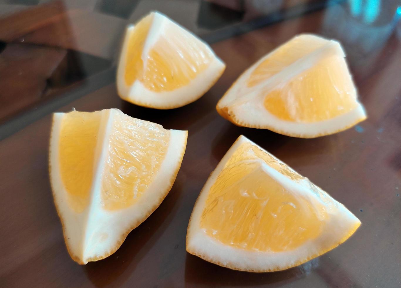 A slice of yellow lemon isolated in white background photo