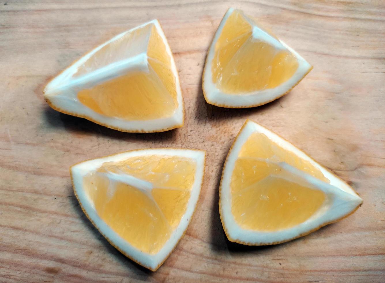 A slice of yellow lemon isolated in white background photo