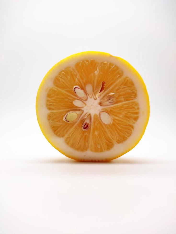 A slice of yellow lemon isolated in white background photo