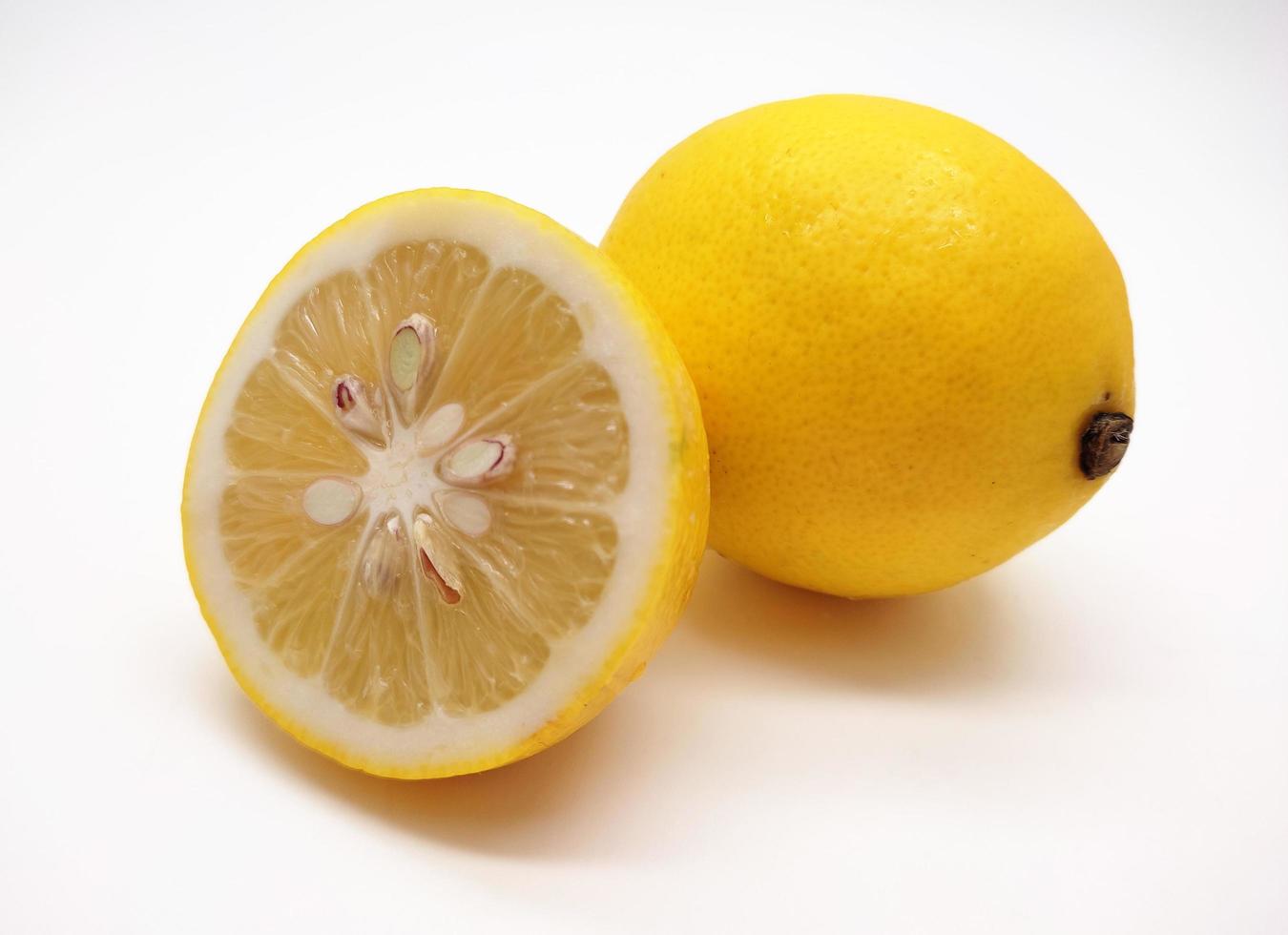 A slice of yellow lemon isolated in white background photo