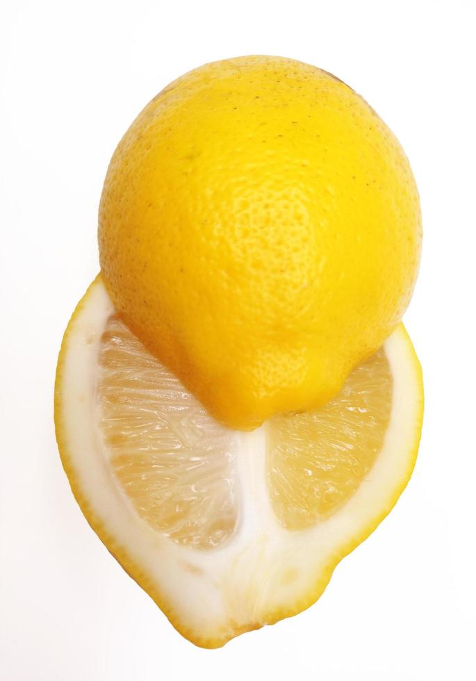 A slice of yellow lemon isolated in white background photo