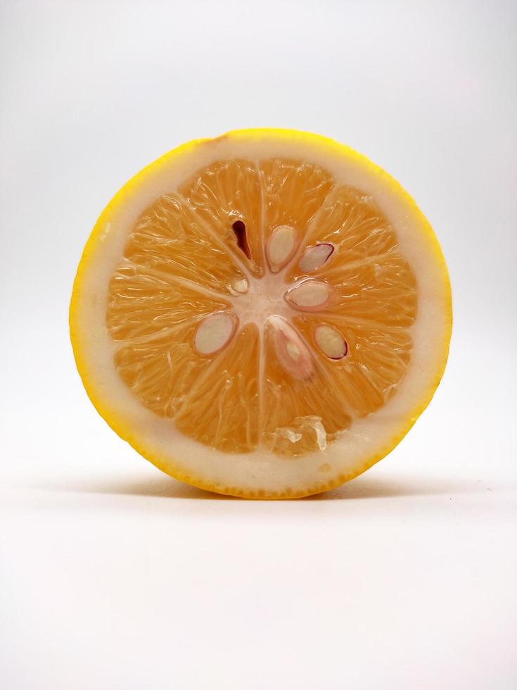 A slice of yellow lemon isolated in white background photo