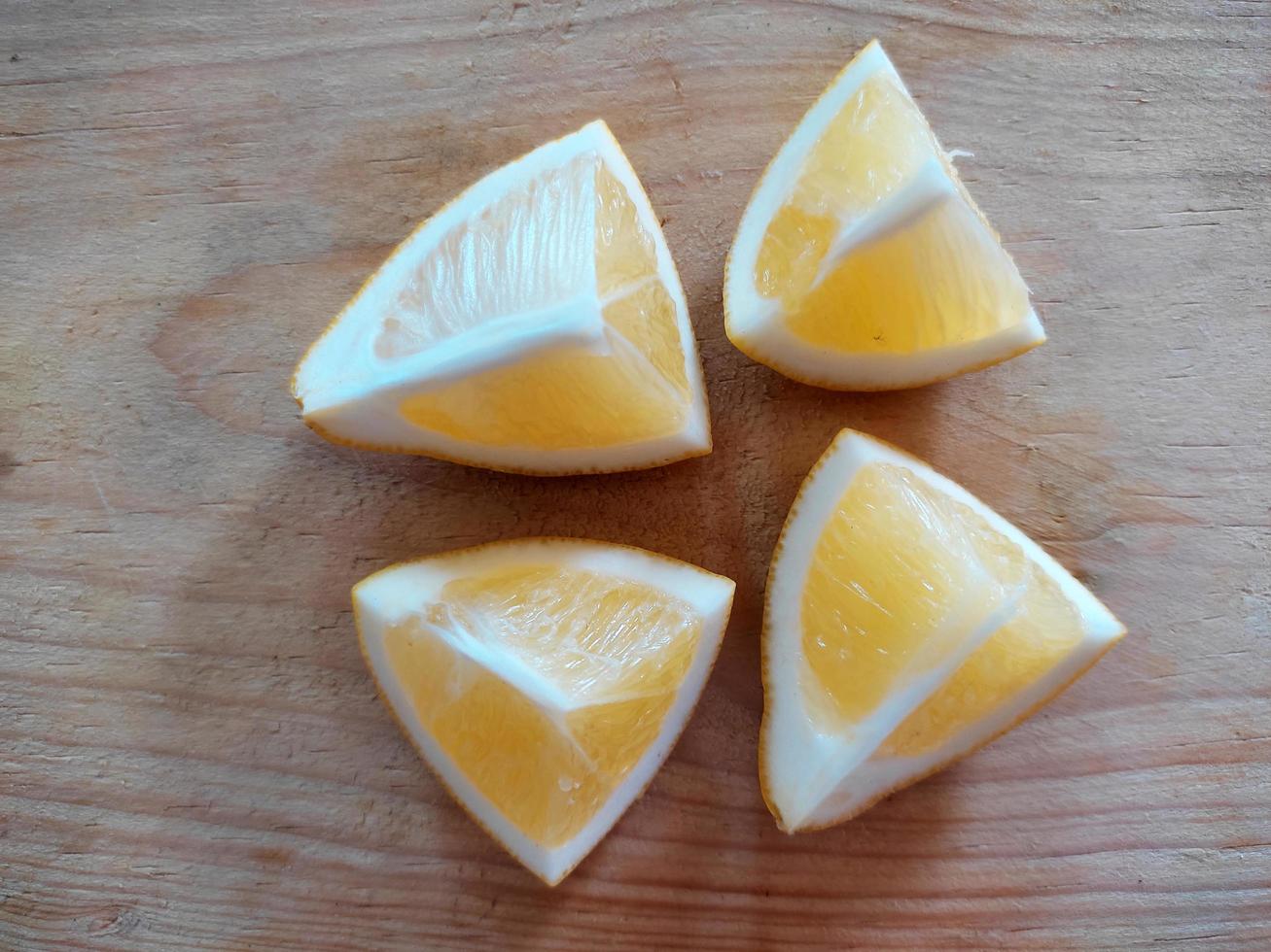 A slice of yellow lemon isolated in white background photo