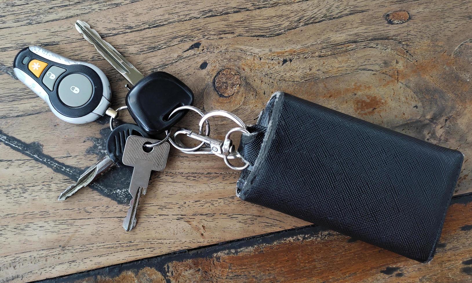 Car key with alarm on wooden table photo