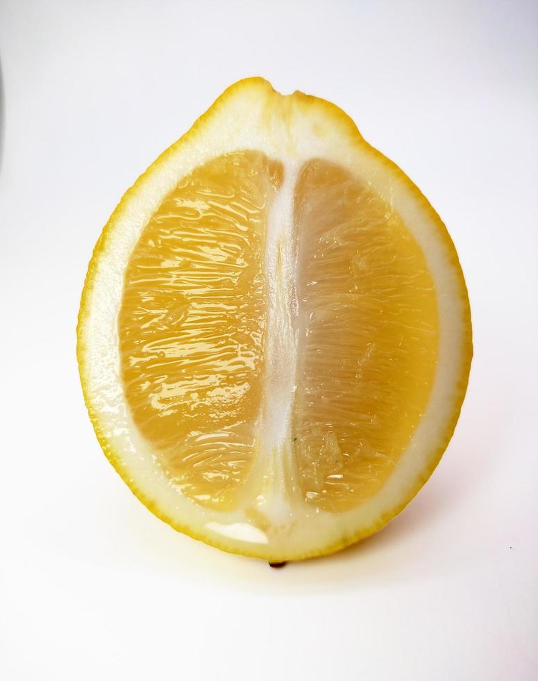 A slice of yellow lemon isolated in white background photo