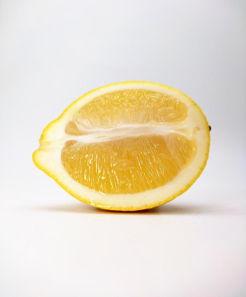 A slice of yellow lemon isolated in white background photo