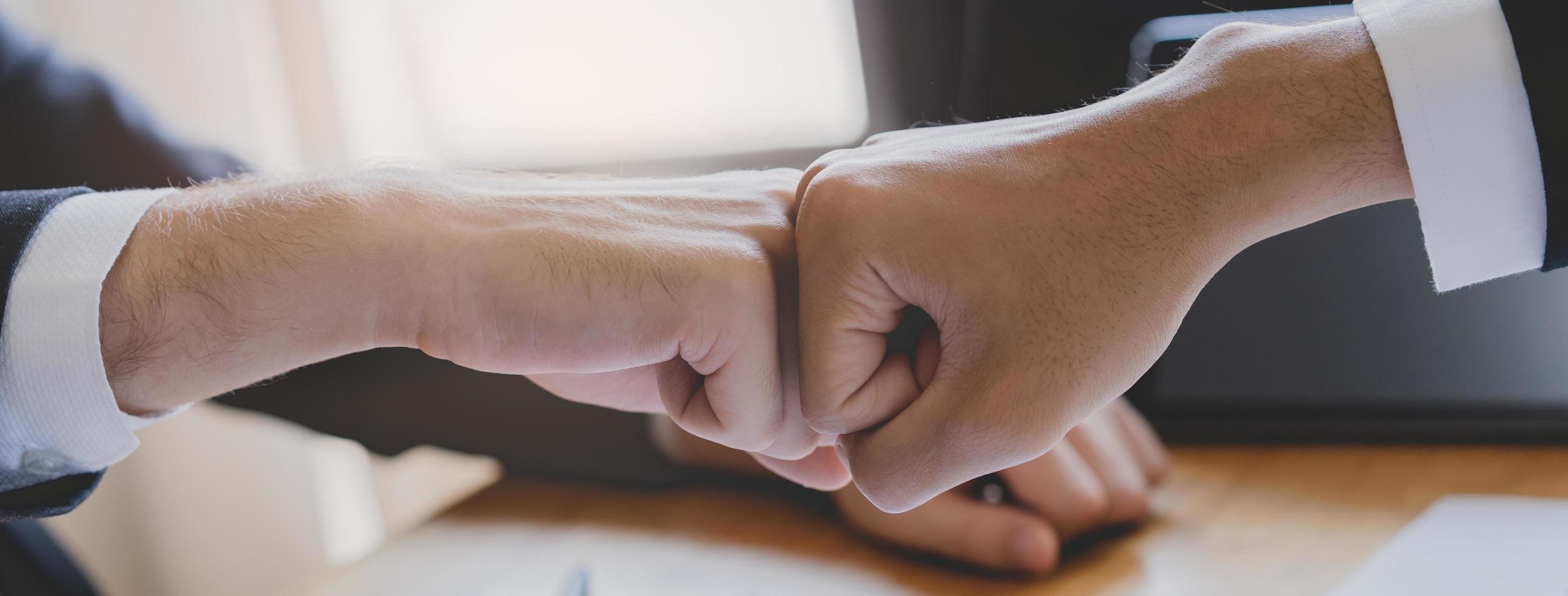 Congrats, business partnership people, two asian and caucasian young man fist bumping, shaking hands together with partnership, customer or colleague after work is done, successful. Worker meeting. photo
