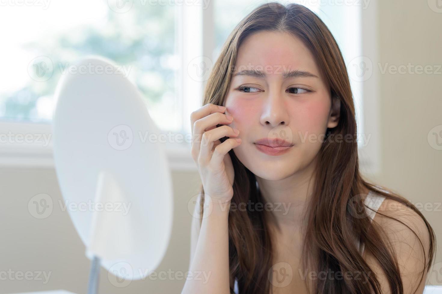 dermatología, pubertad asiático joven mujer, niña mirando dentro espejo, alergia presentación un alérgico reacción desde cosmético, rojo Mancha o erupción en rostro. belleza cuidado desde piel problema por médico tratamiento. foto