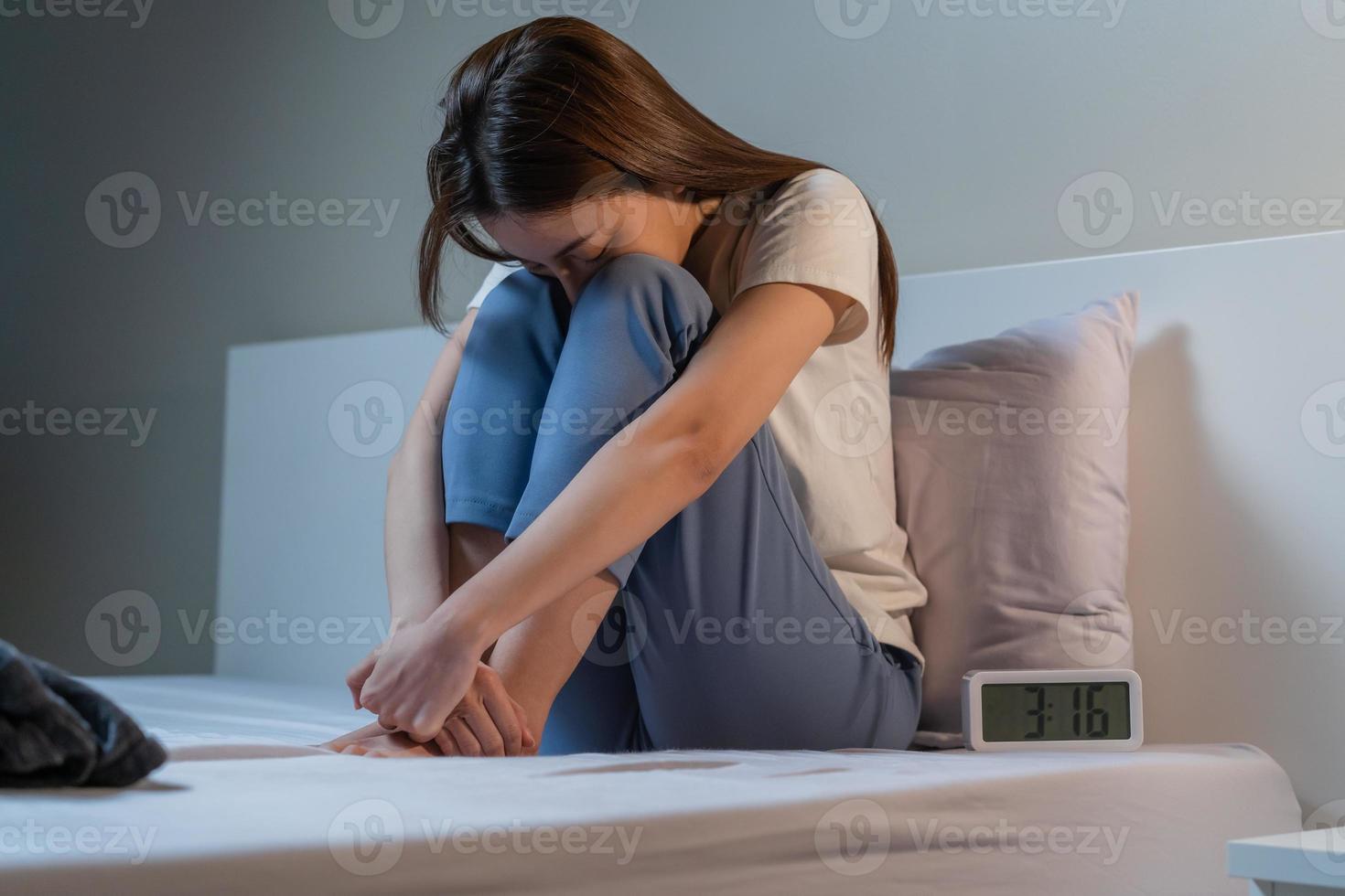 Sad worried and stressed, asian young beautiful, pretty woman, girl suffering from insomnia, awake in the night in bedroom, tired and exhausted. Frustrated people with problem, exhausted on nightmares photo