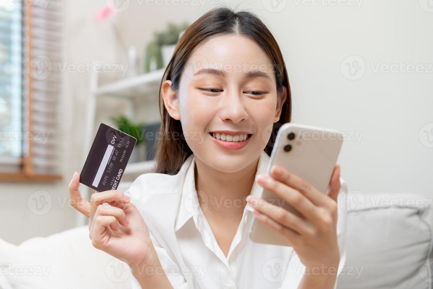 Online internet banking, asian young woman hand in payment spending by scan qr code, use phone, mobile to transfer money or pay money of credit card without cash at home. Technology of financial. photo