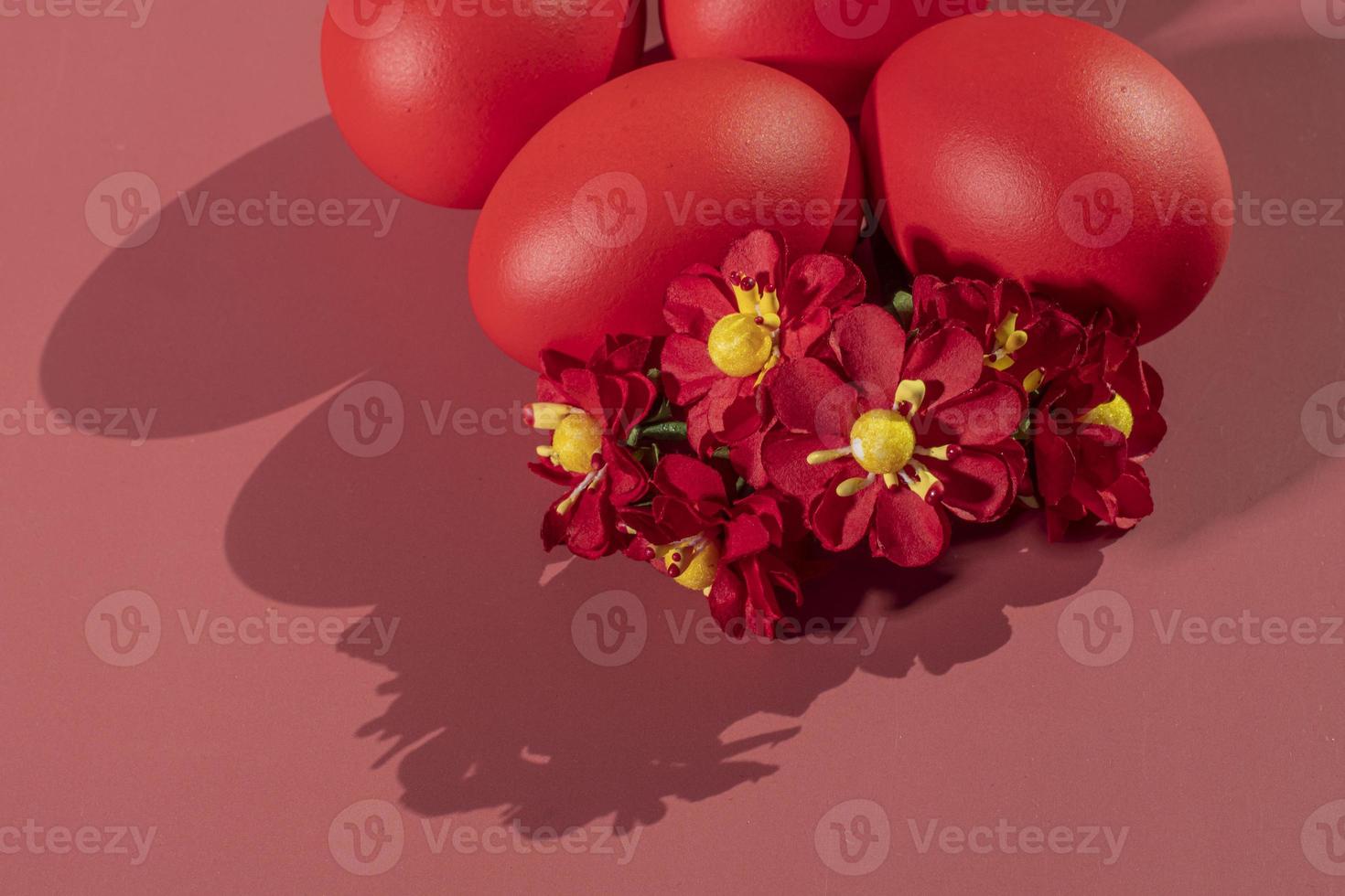 Colorful eggs, symbolizing Easter, on a colorful background and flowers photo