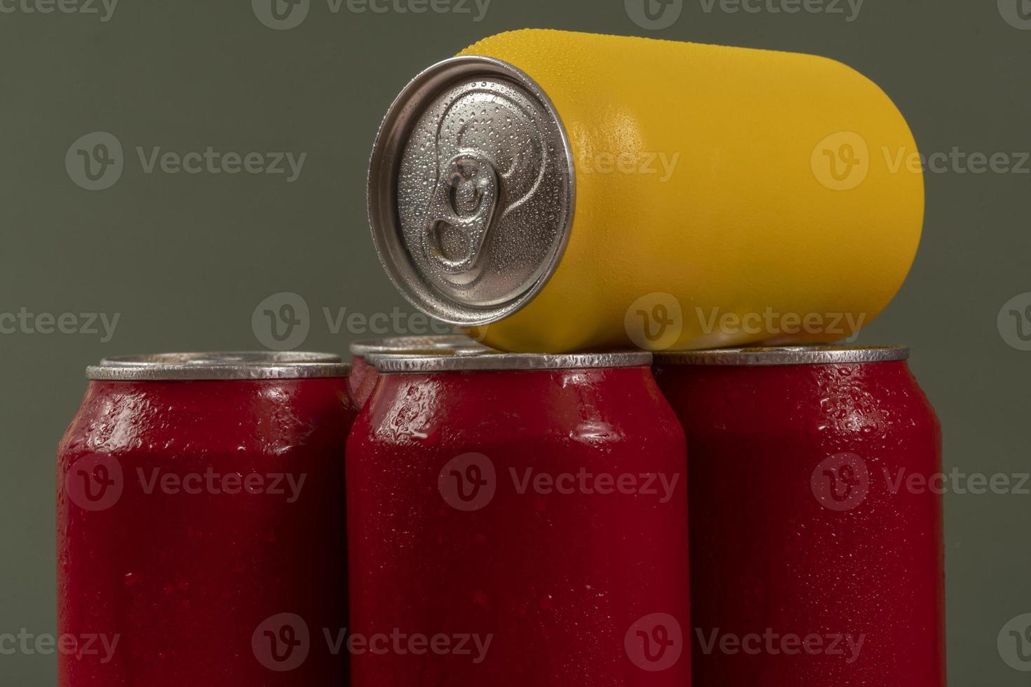 Cold red soda cans with a yellow one for conceptual use photo