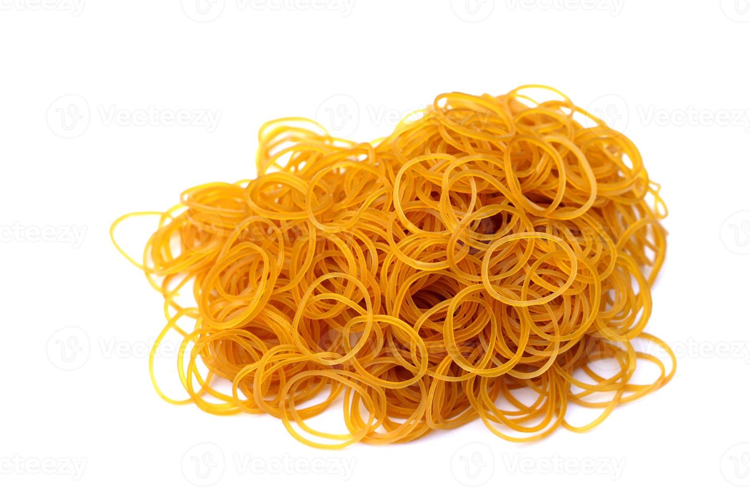 Brown rubber bands isolated on white background. Concept, equipment for fasten, tie general things, bind small objects together,made from natural para rubber. Sticky, flexibility,  used for versatile. photo