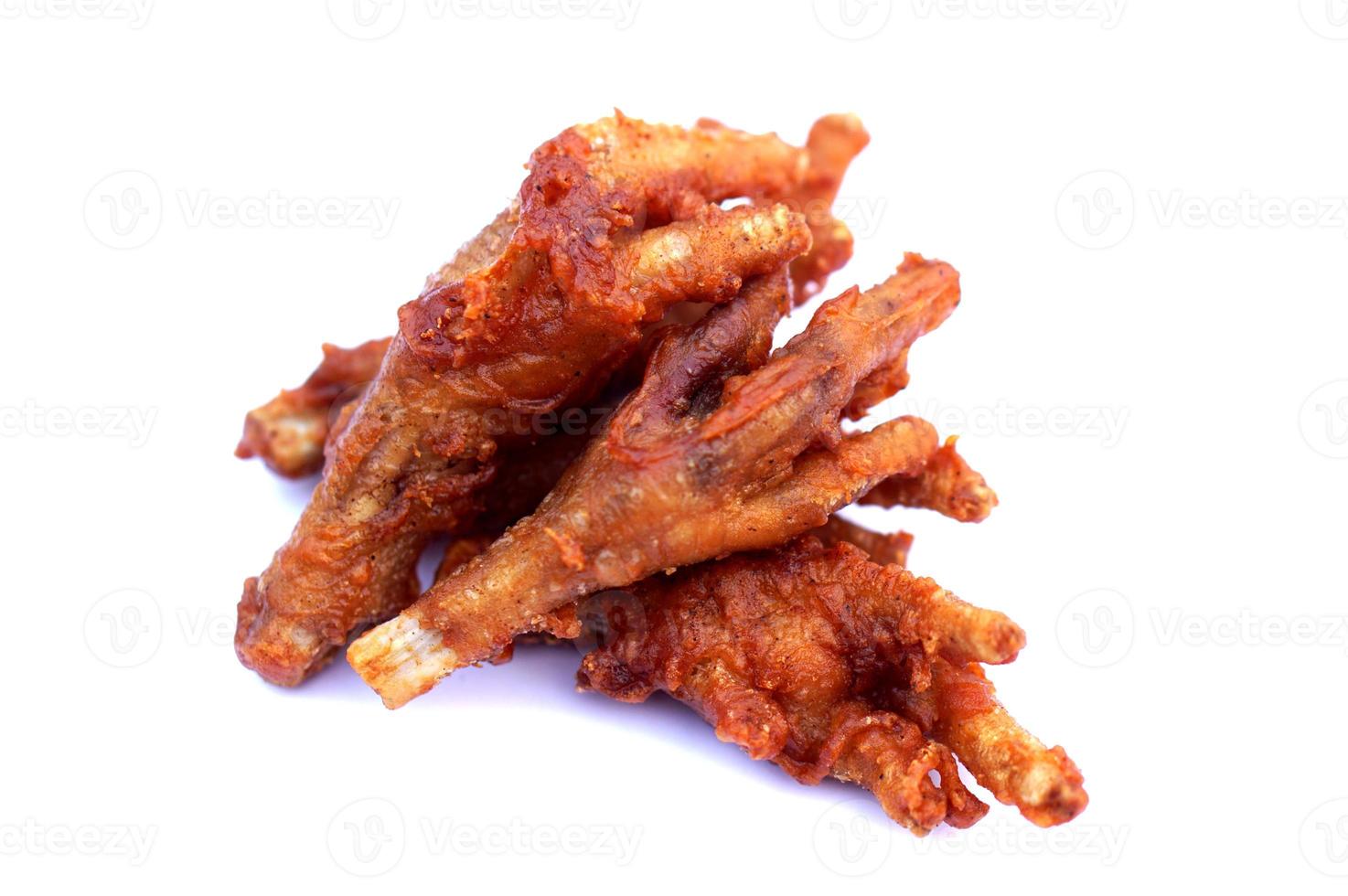 Fried crispy chicken feet isolated on white background. Concept, weird, exotic food. delicious and popular street food in Thailand photo